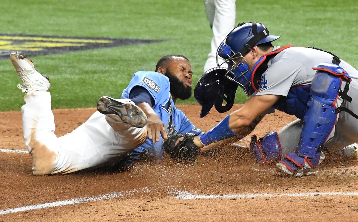 Dodgers catcher Austin Barnes tags out Rays' Manuel Margot, who was attempting to steal home during the fourth inning.