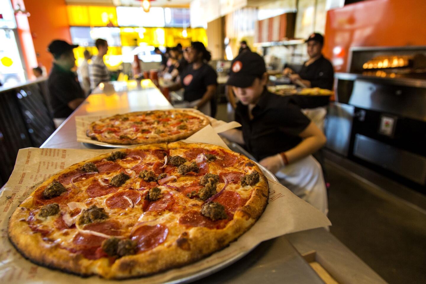A Meat Eater pizza awaits pickup at Blaze Pizza in Pasadena. The chain has six locations now in Southern California, with more coming this year.