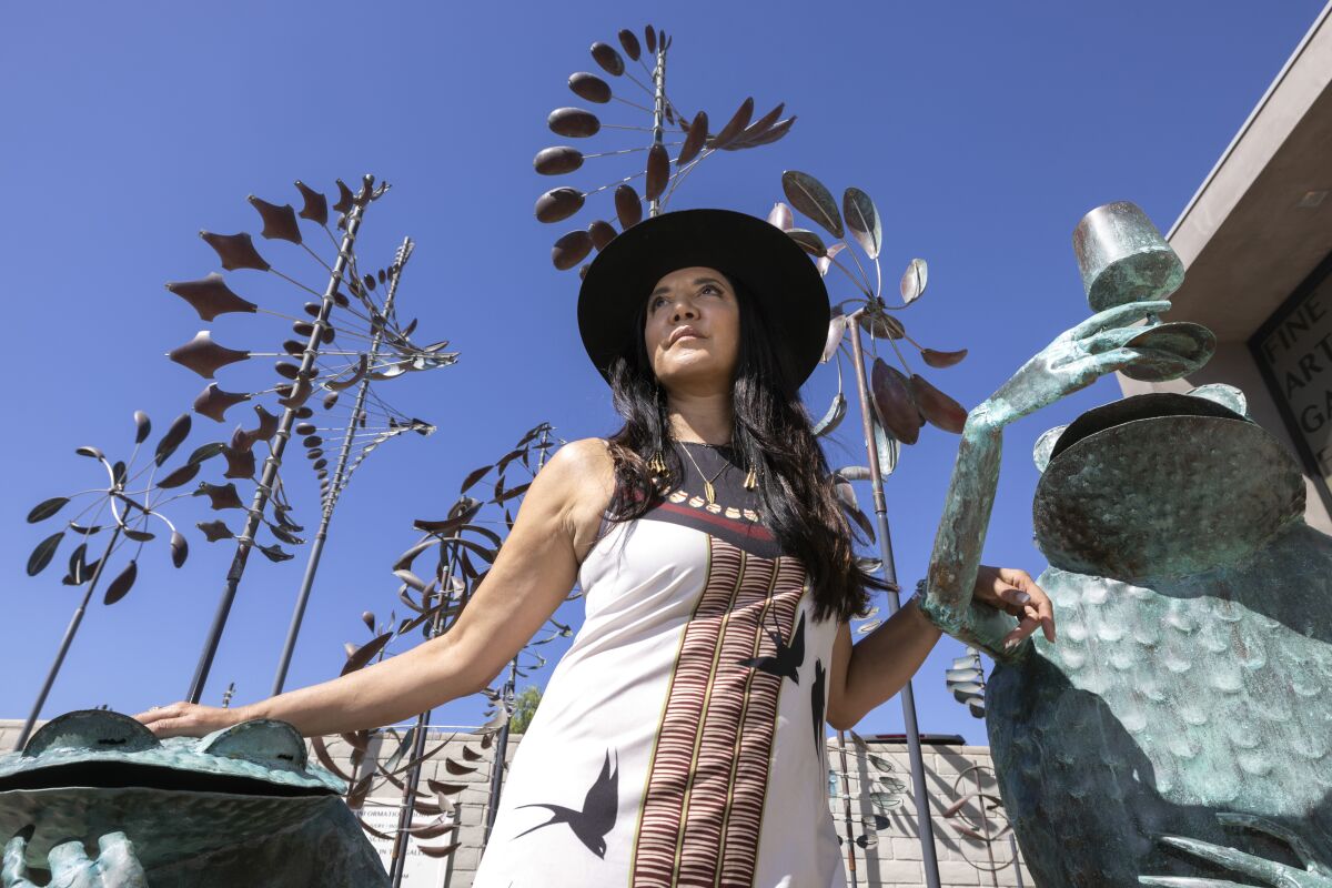 Indigenous entrepreneur Ruth-Ann Thorn stands among sculptures on display in front of the gallery she owns.