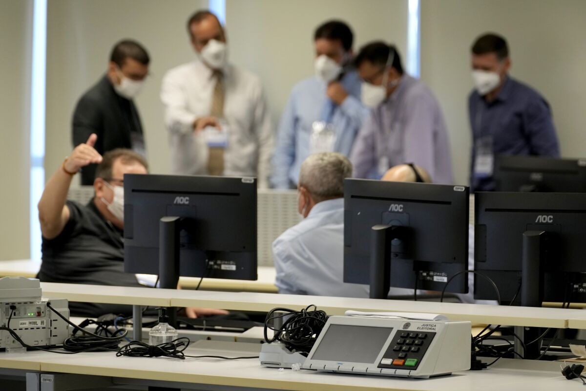 Analysts test the electronic voting system at the headquarters of the Supreme Electoral Court in Brasilia, Brazil, Friday, May 13, 2022. This year, the testing of the voting system is being watched closely as President Jair Bolsonaro casts doubts on the system’s integrity and calls for greater involvement of the armed forces in ensuring reliable results for October's general elections. (AP Photo/Eraldo Peres)