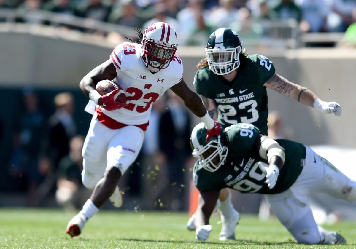 Wisconsin running back Dare Ogunbowale runs with the ball during the game against the Michigan State Spartans on Saturday.