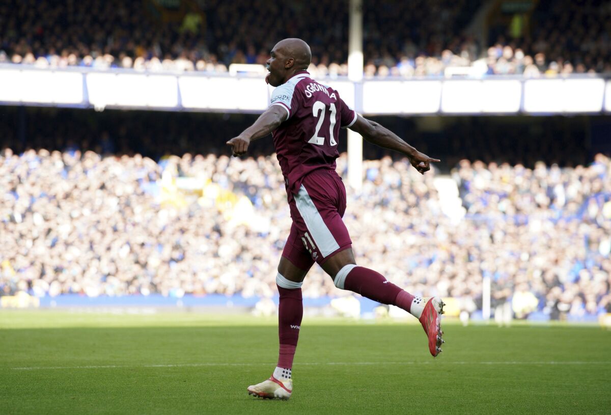 West Ham United's Angelo Ogbonna celebrates after scoring their side's first goal of the game during the English Premier League soccer match between Everton and West Ham United at Goodison Park, Liverpool, England, Sunday, Oct. 17, 2021. (Peter Byrne/PA via AP)