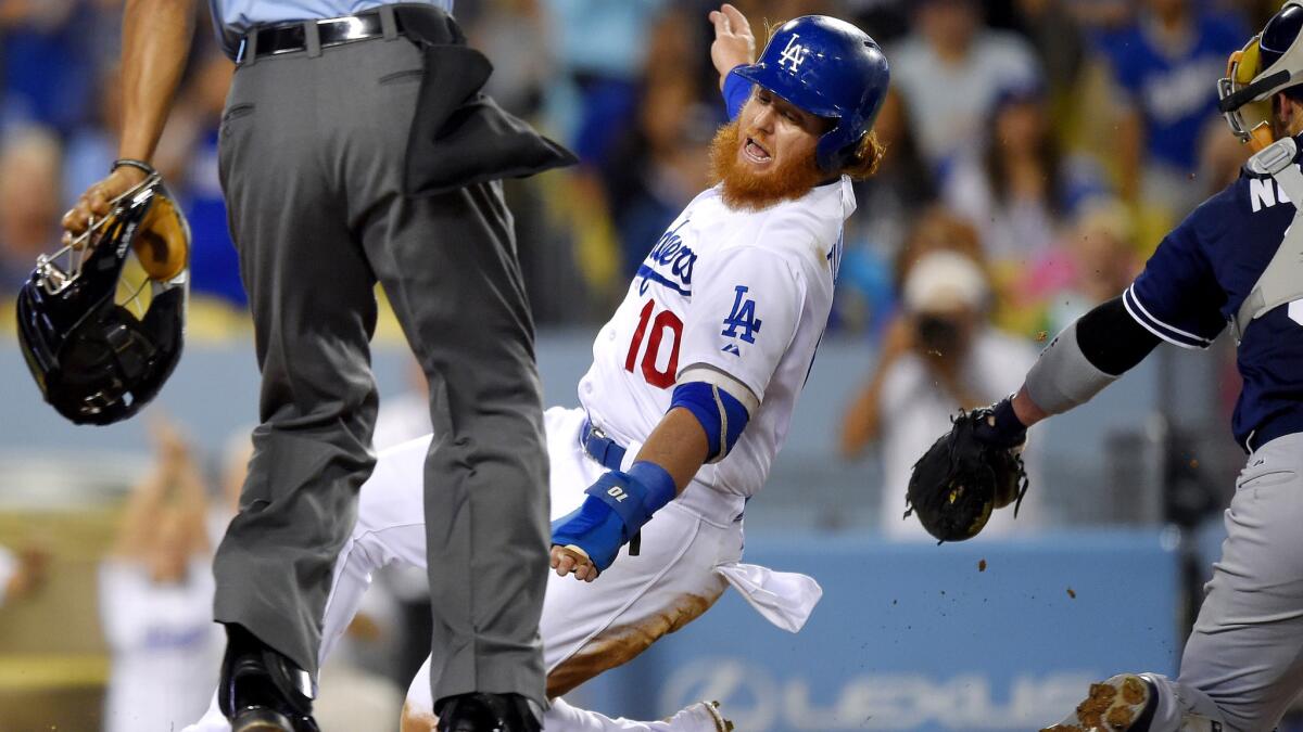 Dodgers third baseman Justin Turner gets past Padres catcher Derek Norris on a single by Corey Seager in the third inning Friday night.