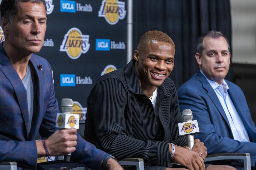 Los Angeles, CA - August 10: Russell Westbrook, center, speaks after being introduced to the media as one of the newest Lakers by vice president of basketball operations/general manager Rob Pelinka, left, and head coach Frank Vogel during a press conference at the Staples Center in Los Angeles Tuesday, Aug. 10, 2021. (Allen J. Schaben / Los Angeles Times)