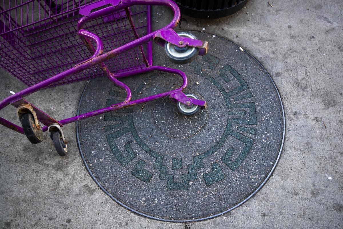 A shopping cart lays on one of dozens of rubber-filled slots with an Aztec design built for future plaques 
