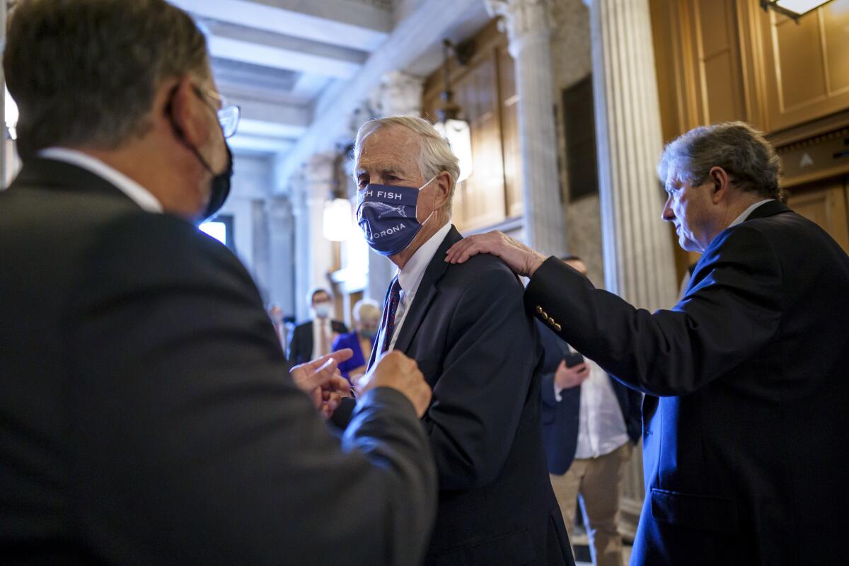 Three senators in the Capitol.