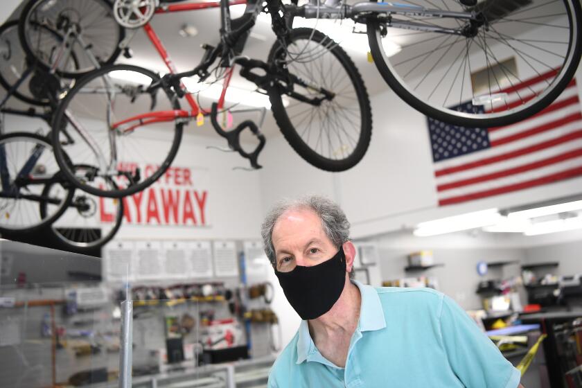 NORWALK, CALIFORNIA MAY 5, 2020-Manager Danny Justman stnands inside Pawnmart business in Norwalk. With the coronavirus pandemic, businesses face challenges even after federal loans. (Wally Skalij/Los Angeles Times)