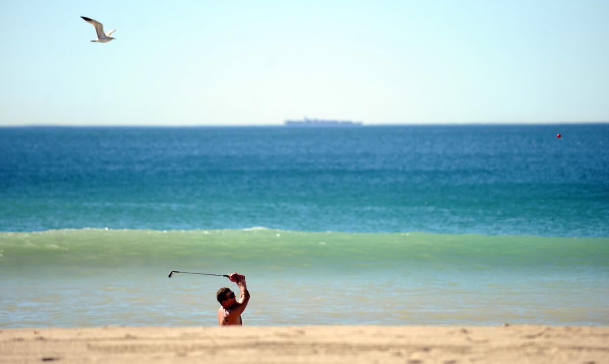 Maui resident Dan Charcoal golfs on Zuma Beach during a hot winter day.