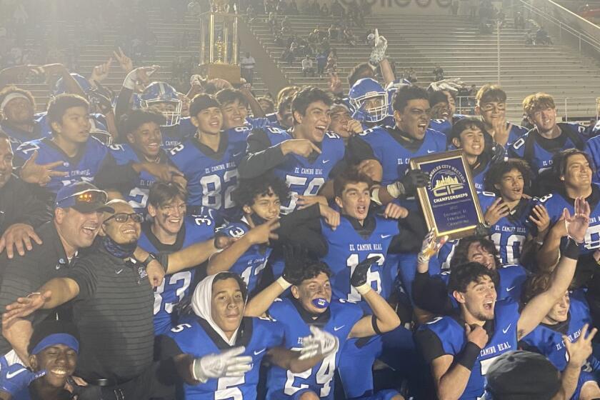 El Camino Real players celebrate a 37-18 victory over Hamilton to win City Section Division II title.