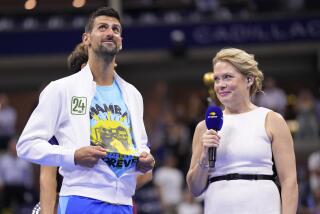 Novak Djokovic, of Serbia, reveals a t-shirt honoring the number 24 and Kobe Bryant.