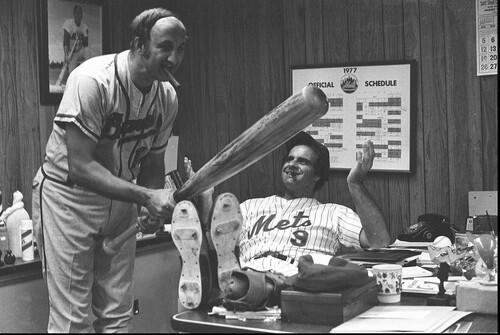 Joe Torre, then managing the Mets, watches his brother Frank swing a bat in 1977.