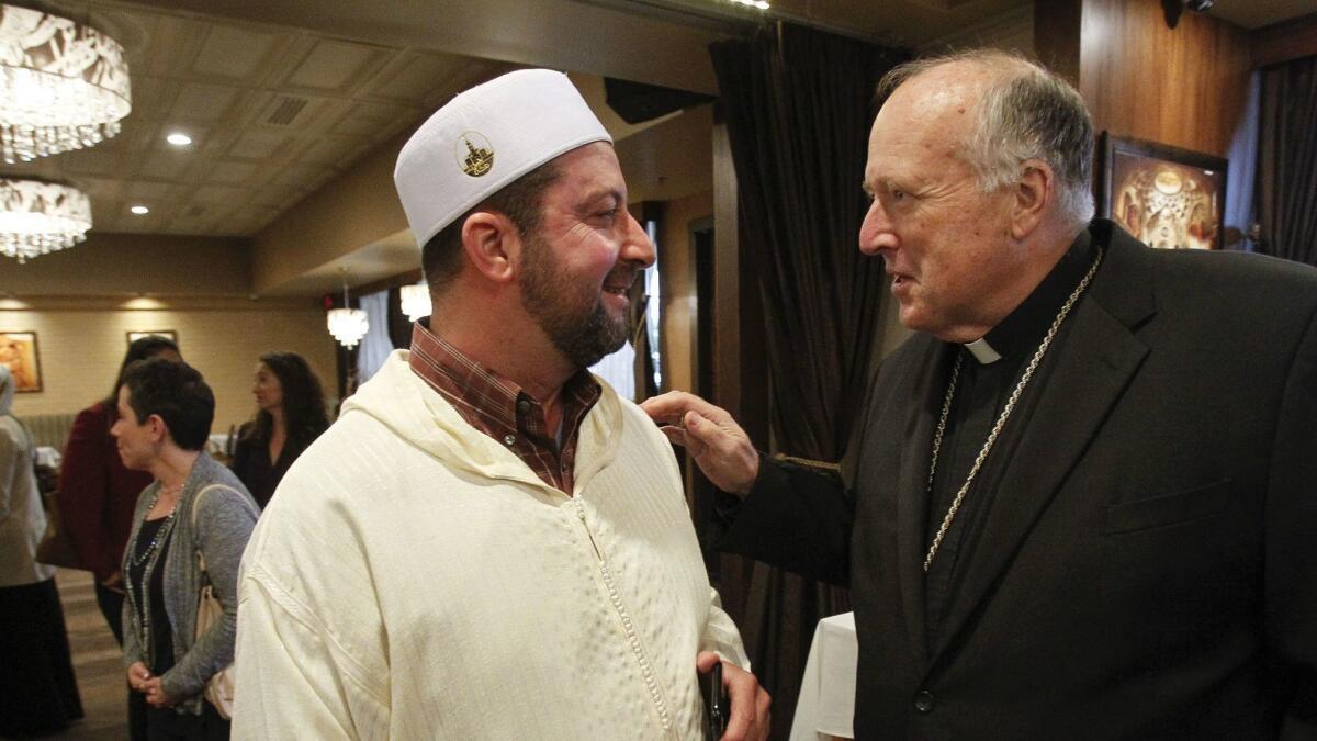 Bishop Robert McElroy speaks to Imam Taha Hassane during the Islamic Center of San Diego 2018 Interfaith Iftar at the Sufi Mediterranean Cuisine restaurant in San Diego on Thursday.