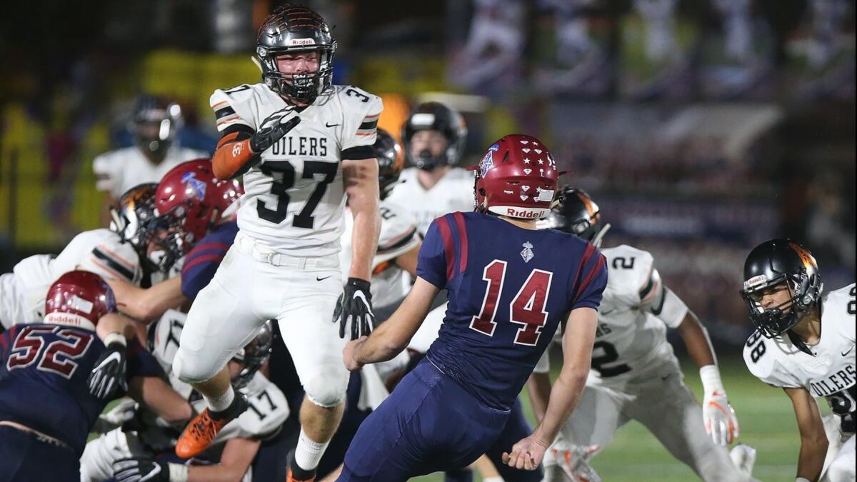 Huntington Beach High's John Gosney (37) blocks a field goal in the first round of the CIF Southern Section Division 6 playoffs at St. Margaret's on Friday.