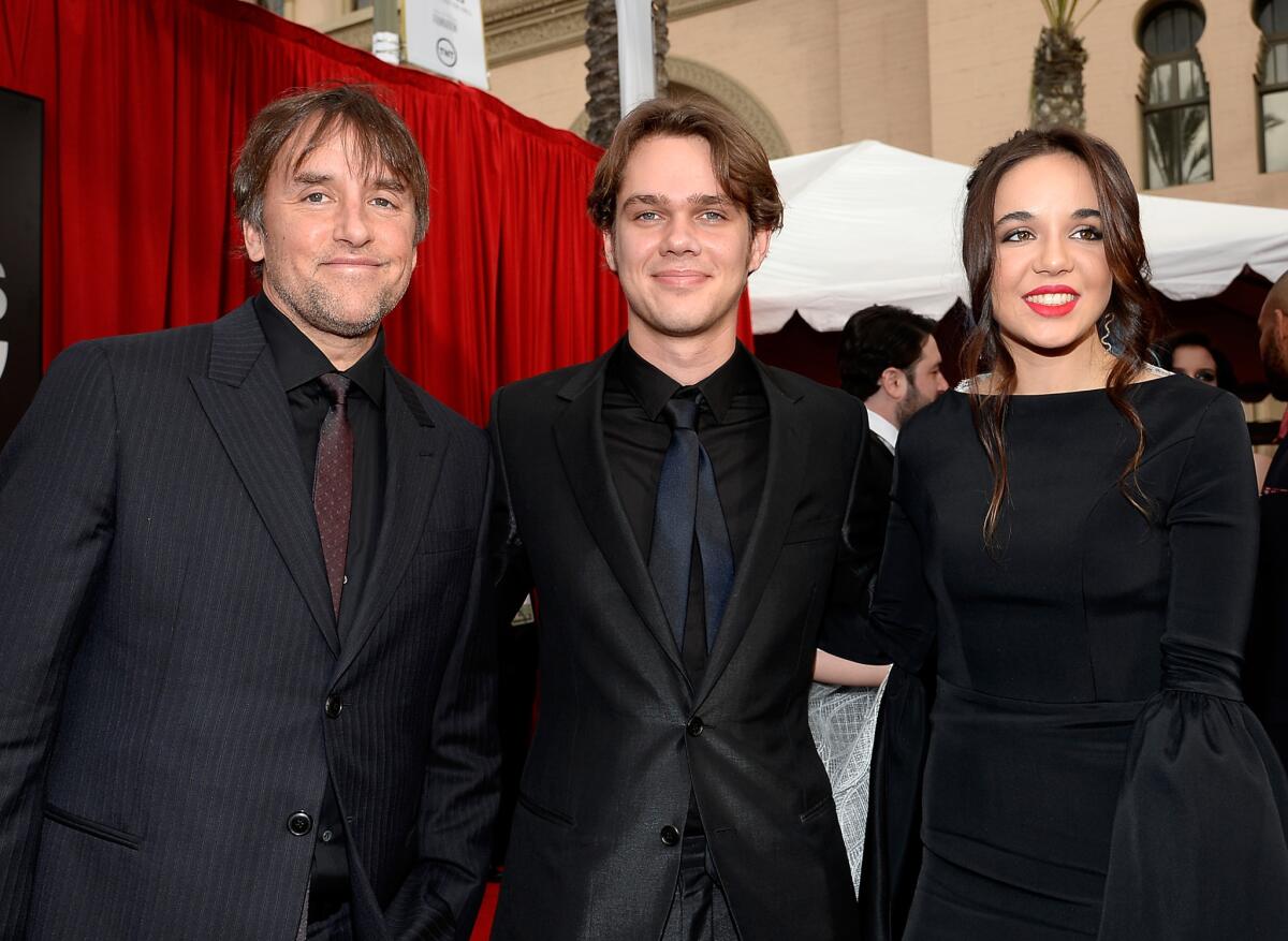 Among the guys who went with the tone-on-tone look at the SAG Awards were director Richard Linklater, left, and actor Ellar Coltrane, center, shown with "Boyhood" costar Lorelei Linklater.