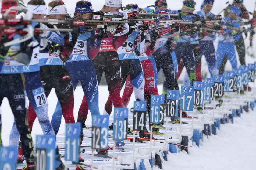 FILE - Athletes shoot during the men's 12.5 km pursuit race at the Biathlon World Cup in Hochfilzen, Austria, Dec. 11, 2021. A flurry of retirements since the 2018 Winter Games has left only a few to defend their Olympic biathlon titles, while a host of talented racers have shown promise this season, making predictions for Beijing success nearly impossible. (AP Photo/Matthias Schrader, File)