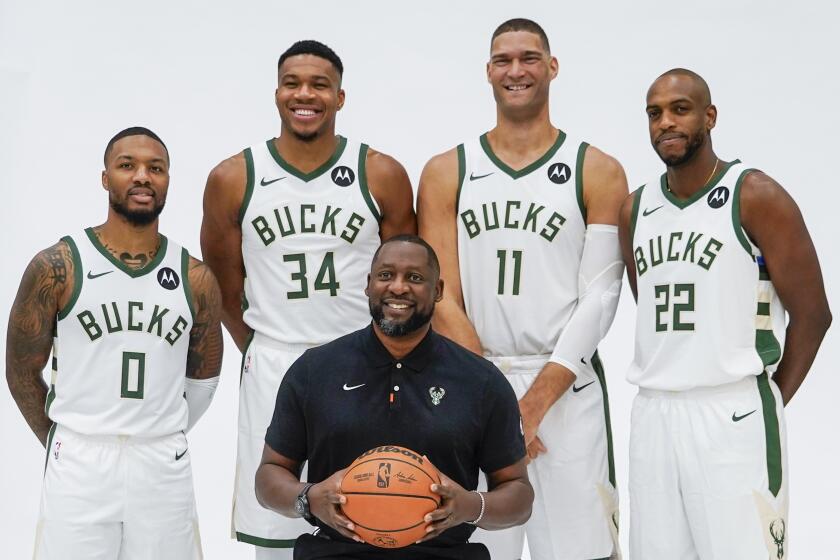 Milwaukee Bucks' Giannis Antetokounmpo, Damian Lillard, Brook Lopez, Khris Middleton and head coach Adrian Griffin pose for a picture during the NBA basketball team's media day in Milwaukee Monday, Oct. 2, 2023. (AP Photo/Morry Gash)