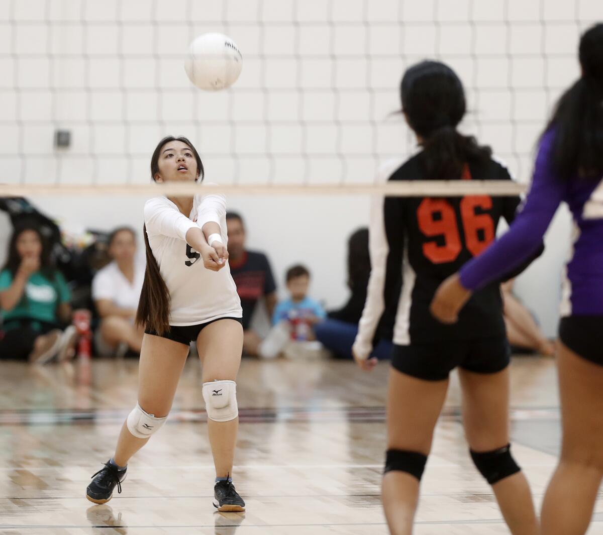 Los Amigos' Kim Mai digs the ball against Santiago during the first set of a Garden Grove League match at home Tuesday.