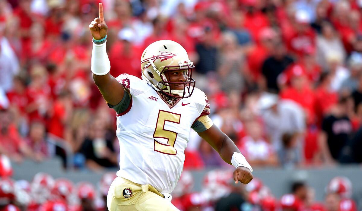 Florida State quarterback Jameis Winston celebrates after throwing a touchdown pass against North Carolina State in the first half Saturday afternoon.