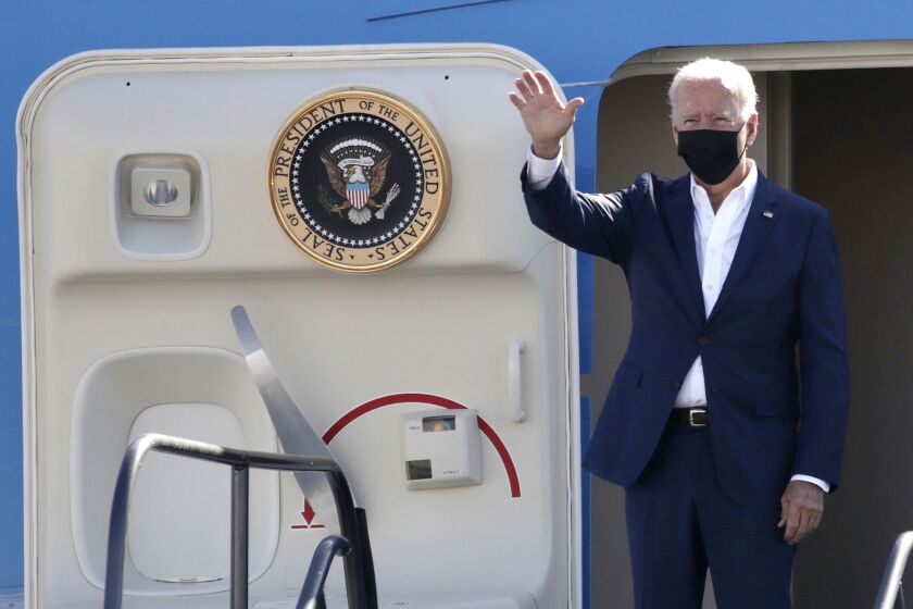 LONG BEACH CA SEPTEMBER 14, 2021 - President Joe Biden waves as he boards Air Force One at Long Beach Airport, Tuesday, Sept. 14, 2021, in Long Beach, Calif. (irfan Khan / Los Angeles Times)