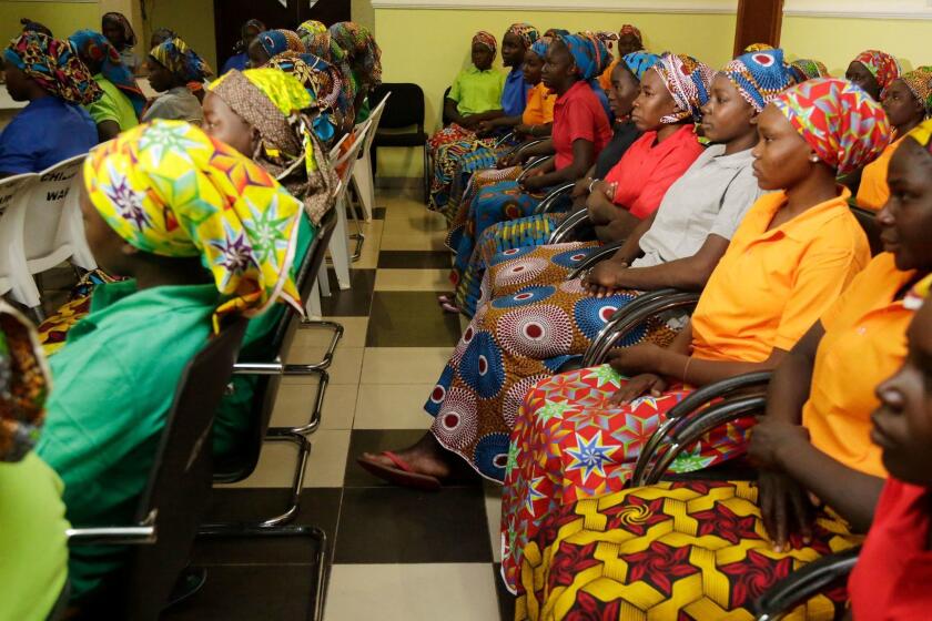 Chibok schoolgirls, recently freed from Nigeria extremist captivity, are photographed in Abuja, Nigeria, Monday May 8, 2017. Nigeria's presidency has released the names of the 82 Chibok schoolgirls newly freed from the Boko Haram extremists. The list was released late Sunday night after Nigerian President Muhammadu Buhari met with the young women before leaving for London for medical checkups as fears for his health continue. (AP Photo/Sunday Alamba)