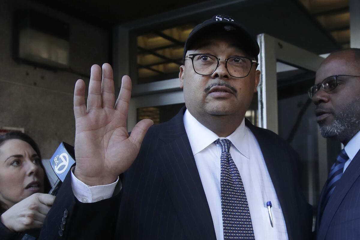 Mohammed Nuru, center, leaves a federal courthouse with attorney Ismail Ramsey, right, on Feb. 6, 2020.