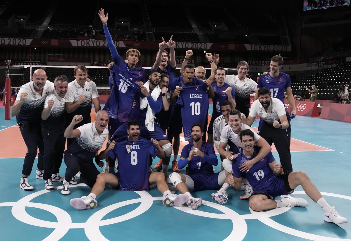 Team France poses for a group photo after winning the men's volleyball gold medal match against the Russian Olympic Committee, at the 2020 Summer Olympics, Saturday, Aug. 7, 2021, in Tokyo, Japan. (AP Photo/Manu Fernandez)