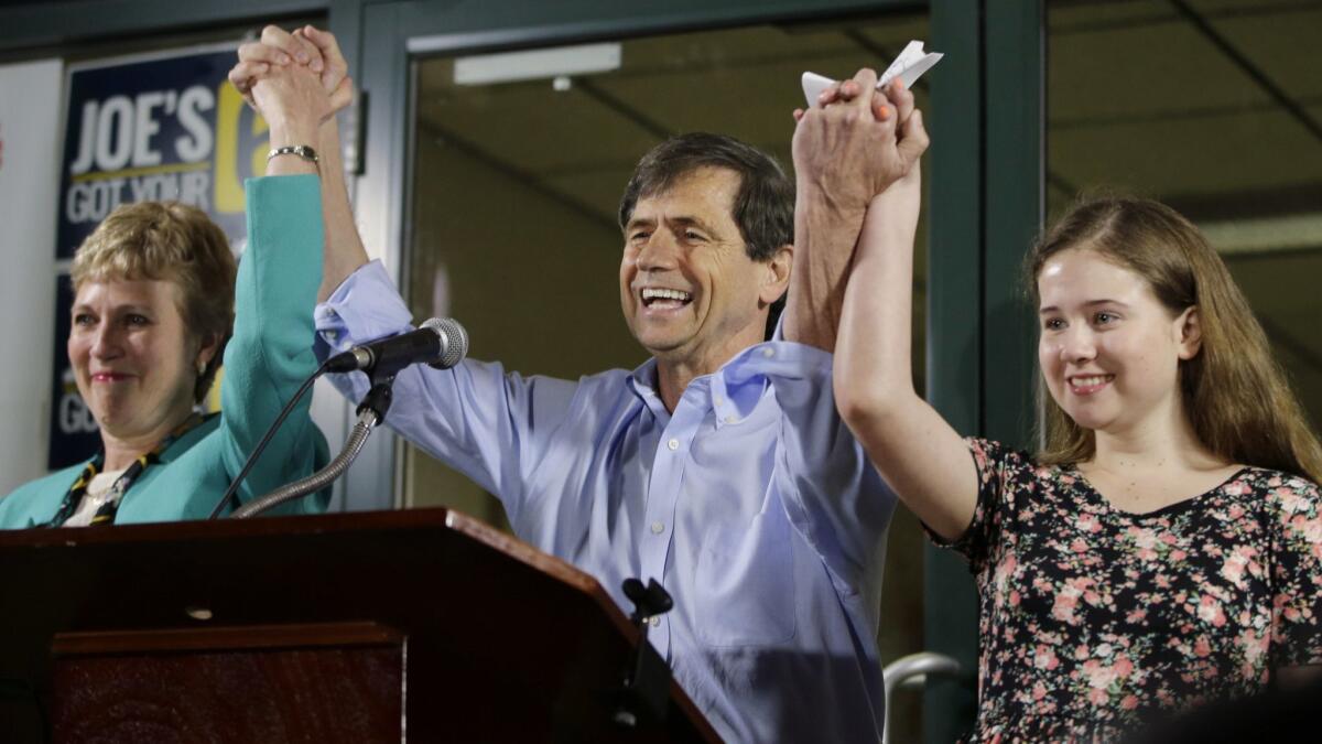 Former congressman Joe Sestak, center, his wife, Susan Sestak, and daughter Alex Sestak react after speaking to supporters gathered outside his campaign headquarters in Media, Pa., in 2016.