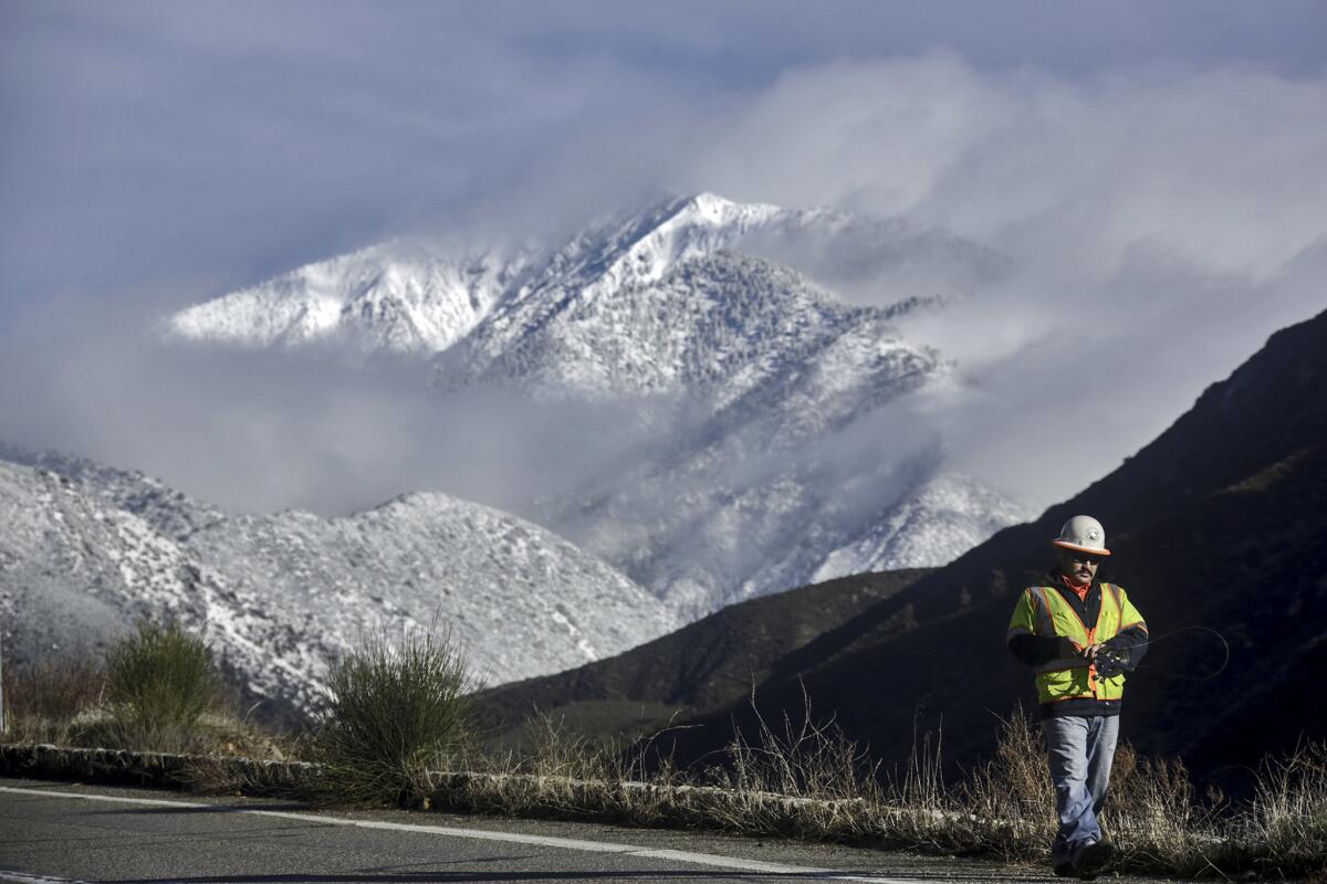 A surveyor works on Mt. Baldy Road in January.