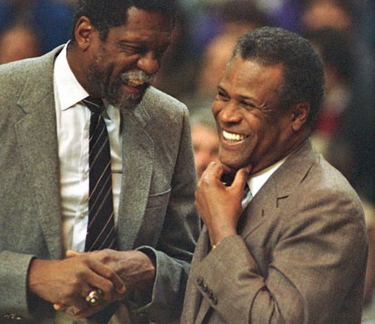 Celtics coach K.C. Jones, right, greets Sacramento coach and former teammate Bill Russell during an NBA game in 1988. 