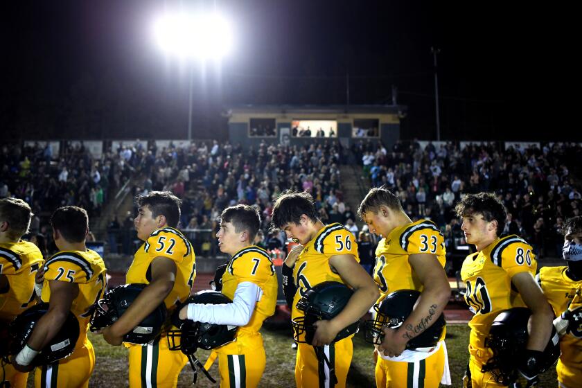 PARADISE, CALIFORNIA OCTOBER 18, 2019-Members of the Paradise High School football team stand for the National Anthem before a game against Willows Friday night. (Wally Skalij/Los Angeles Times)