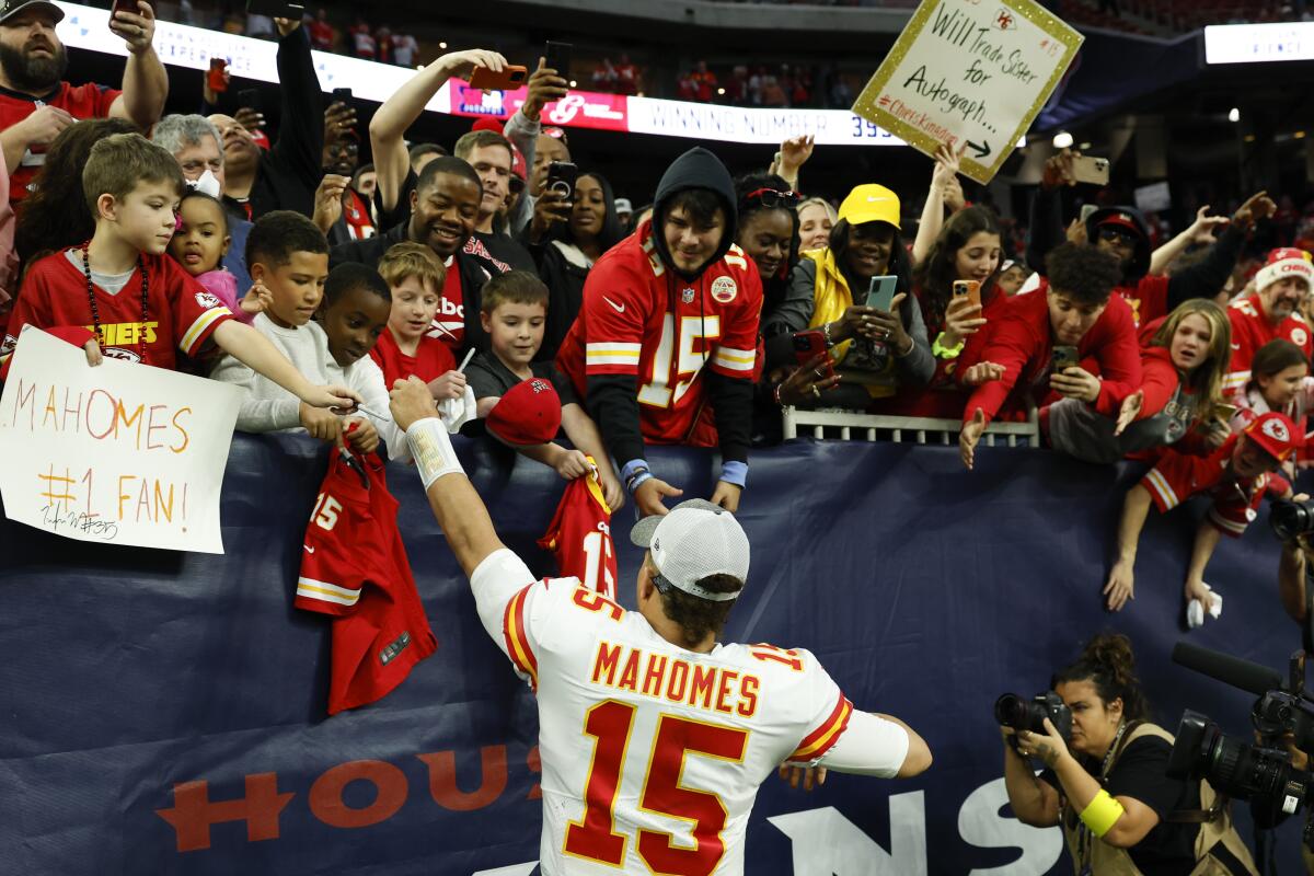 Chiefs quarterback Patrick Mahomes signs autographs for fans after the AFC championship game.
