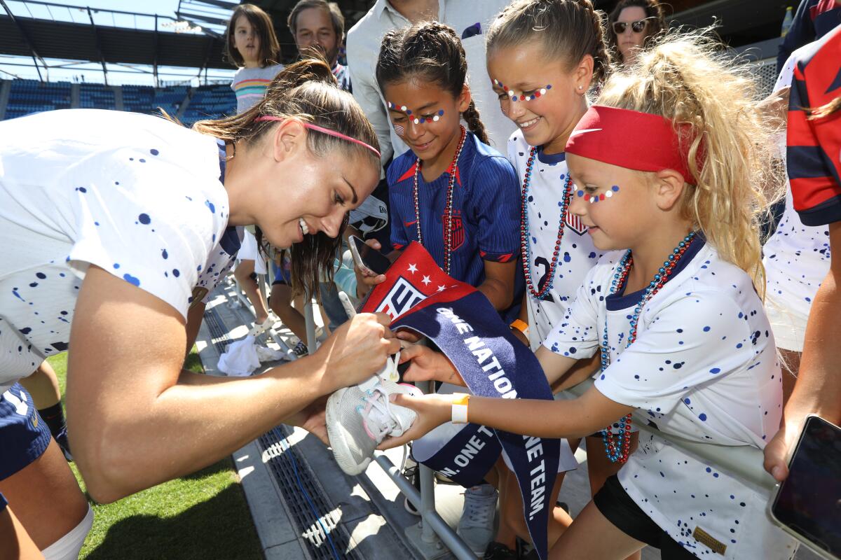 Alex Morgan signs autographs before a friendly against Wales this month.