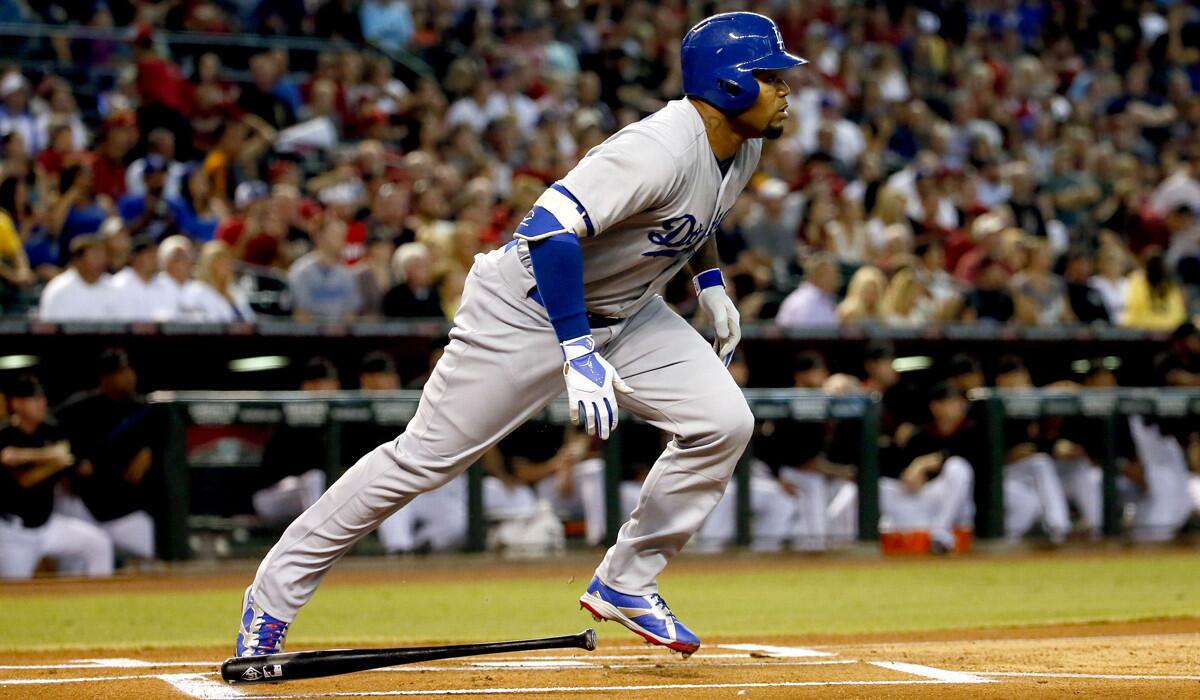 The Dodgers' Carl Crawford follows through on a solo home run against the Arizona Diamondbacks during the first inning on Saturday.