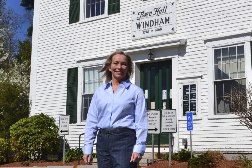 In this May 7, 2021 photo, Kristi St. Laurent, who ran for a House seat in the 2020 election, poses in front of Town Hall in Windham, N.H. St. Laurent, who requested a recount after losing the 2020 election by 24 votes, has led to a debate over the integrity of the election in Windham and prompted Trump supporters to suggest the dispute could illustrate wider problems with the election system. (AP Photo/Michael Casey)