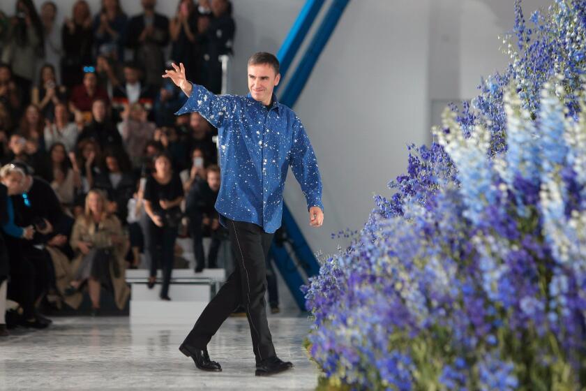 Designer Raf Simons waves to the crowd after presenting the Christian Dior spring/summer 2016 ready-to-wear collection on Oct. 2, 2015, during Paris Fashion Week.