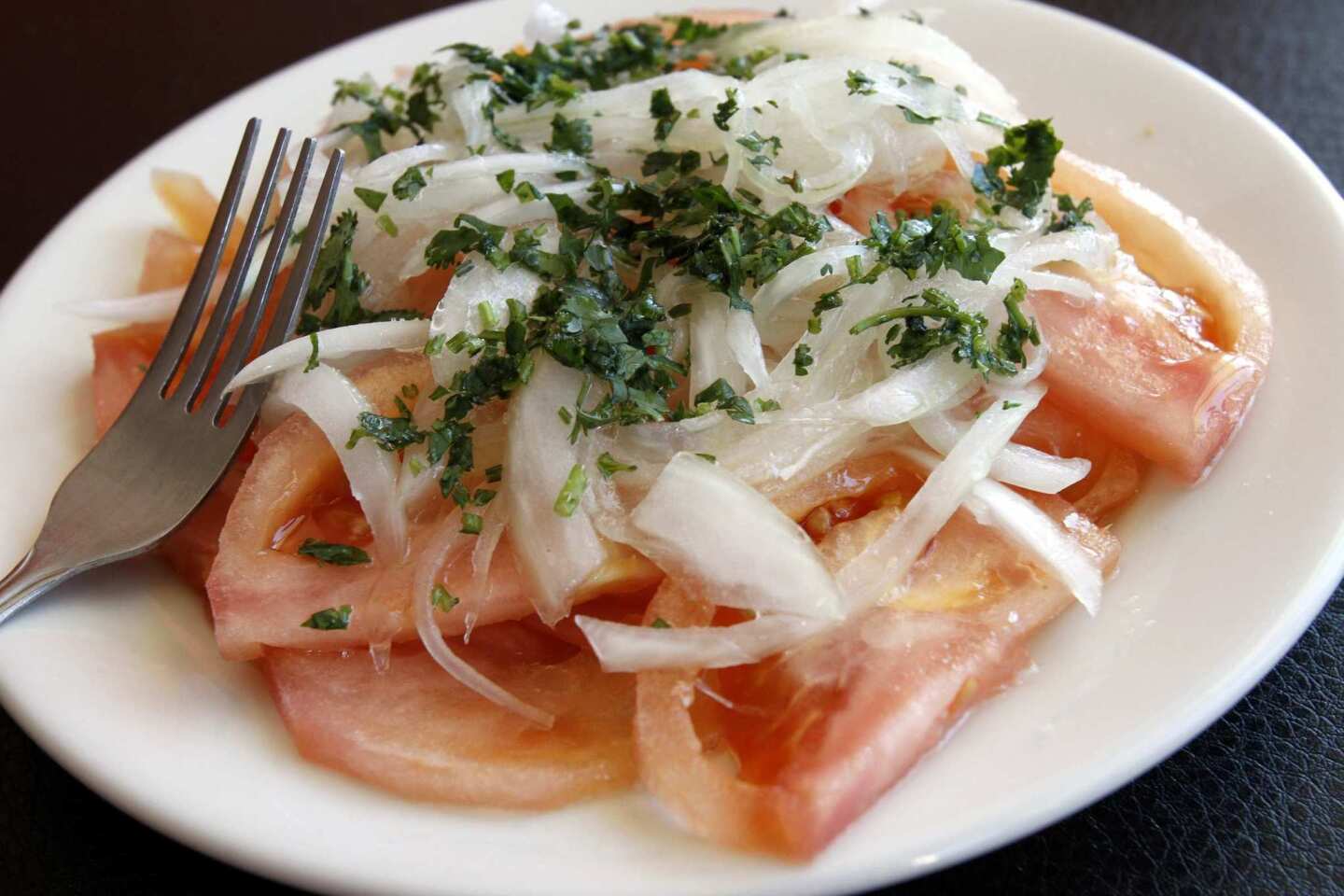 The Chilean salad includes tomato, onion and cilantro.