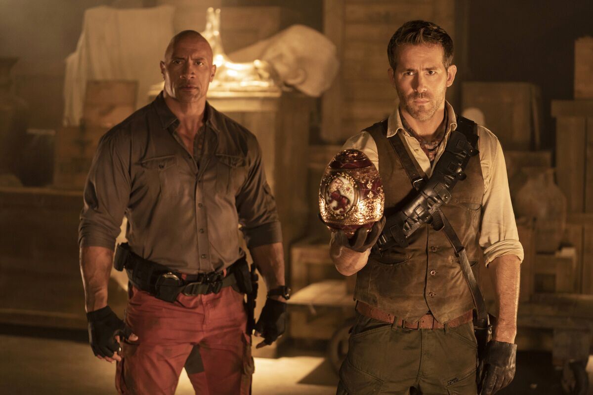 Two men equipped with guns surronded by artifacts. The one on the right holds a large golden egg