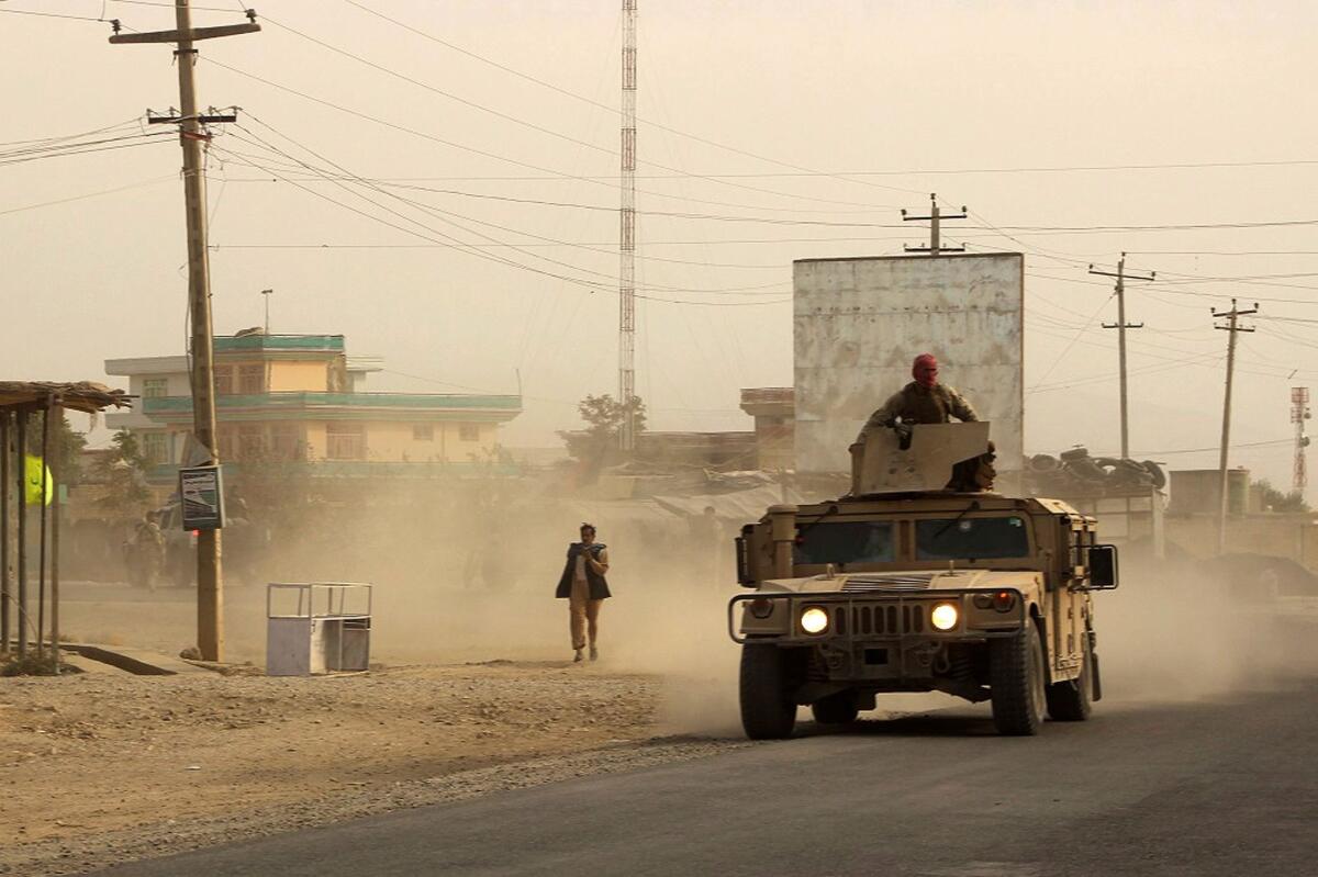 Afghan security forces travel in a Humvee on Monday as fighting continues between Taliban militants and government forces in Kunduz, capital of Kunduz province.