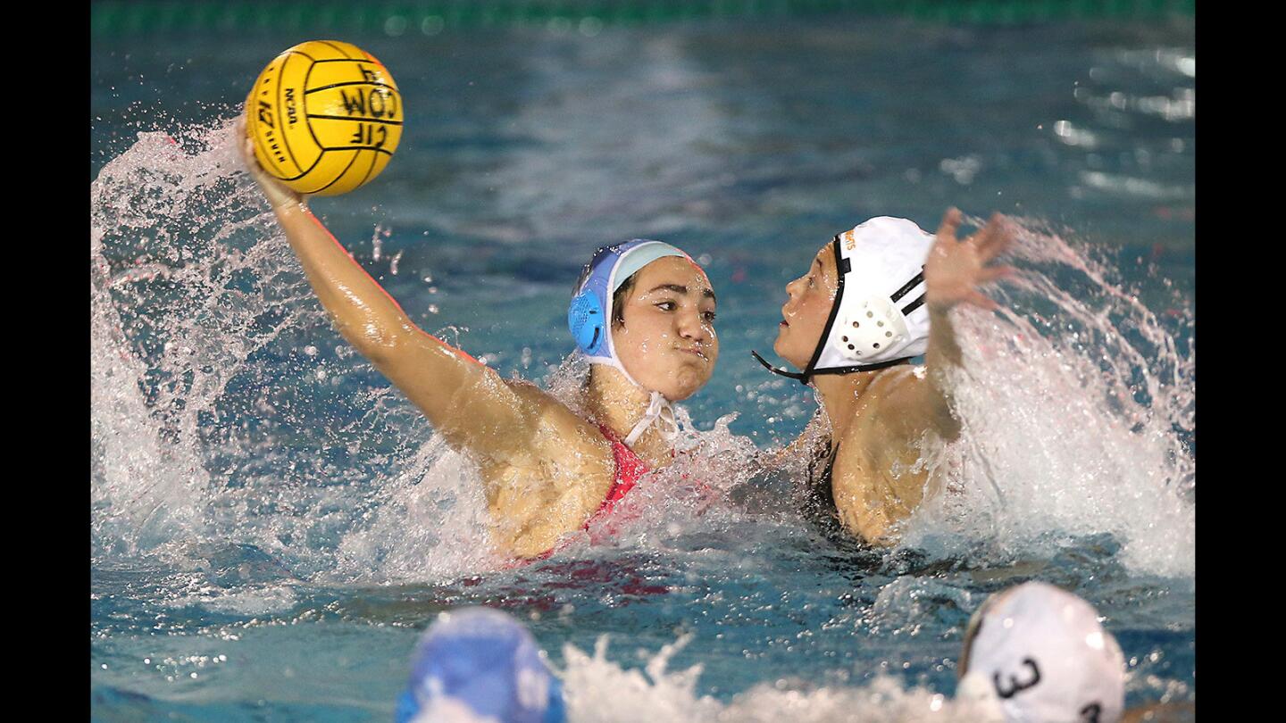 Corona Del Mar's Chloe Harbilas, 12, ties the game despite Foothills Valeria Ayala's defense during the quarterfinals of the CIF Southern Section Division 1 playoffs on Thursday.
