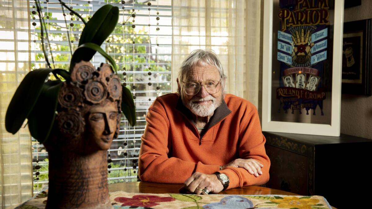 Retired Disney Imagineer Rolly Crump, 88, who was pivotal in the designs of many key Disneyland attractions. Crump's Disney window, displayed on Disneyland's Main Street, U.S.A., is behind him.