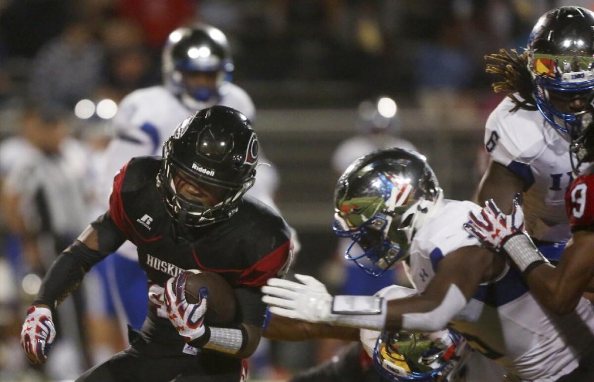 Running back Miles Reed of Corona Centennial picks up yards against IMG Academy.