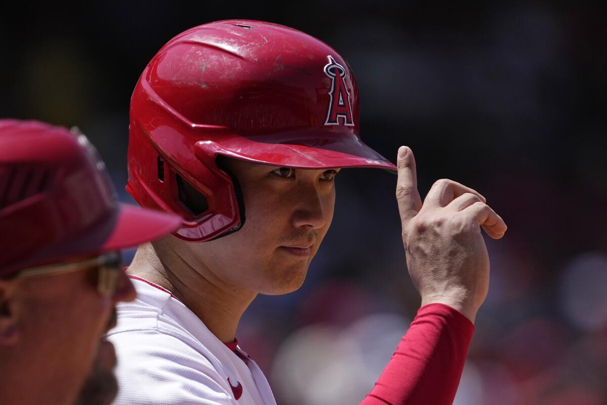 Angels star Shohei Ohtani acknowledges the first base umpire by pointing.