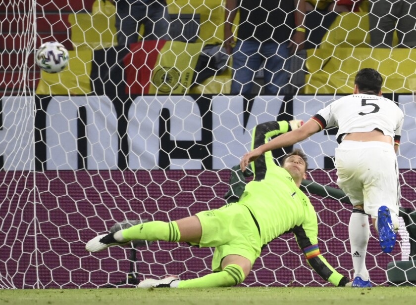 Germany's Mats Hummels, right, scores an own goal past Germany's goalkeeper Manuel Neuer during the Euro 2020 soccer championship group F match between Germany and France at the Allianz Arena stadium in Munich, Tuesday, June 15, 2021. (Franck Fife/Pool via AP)