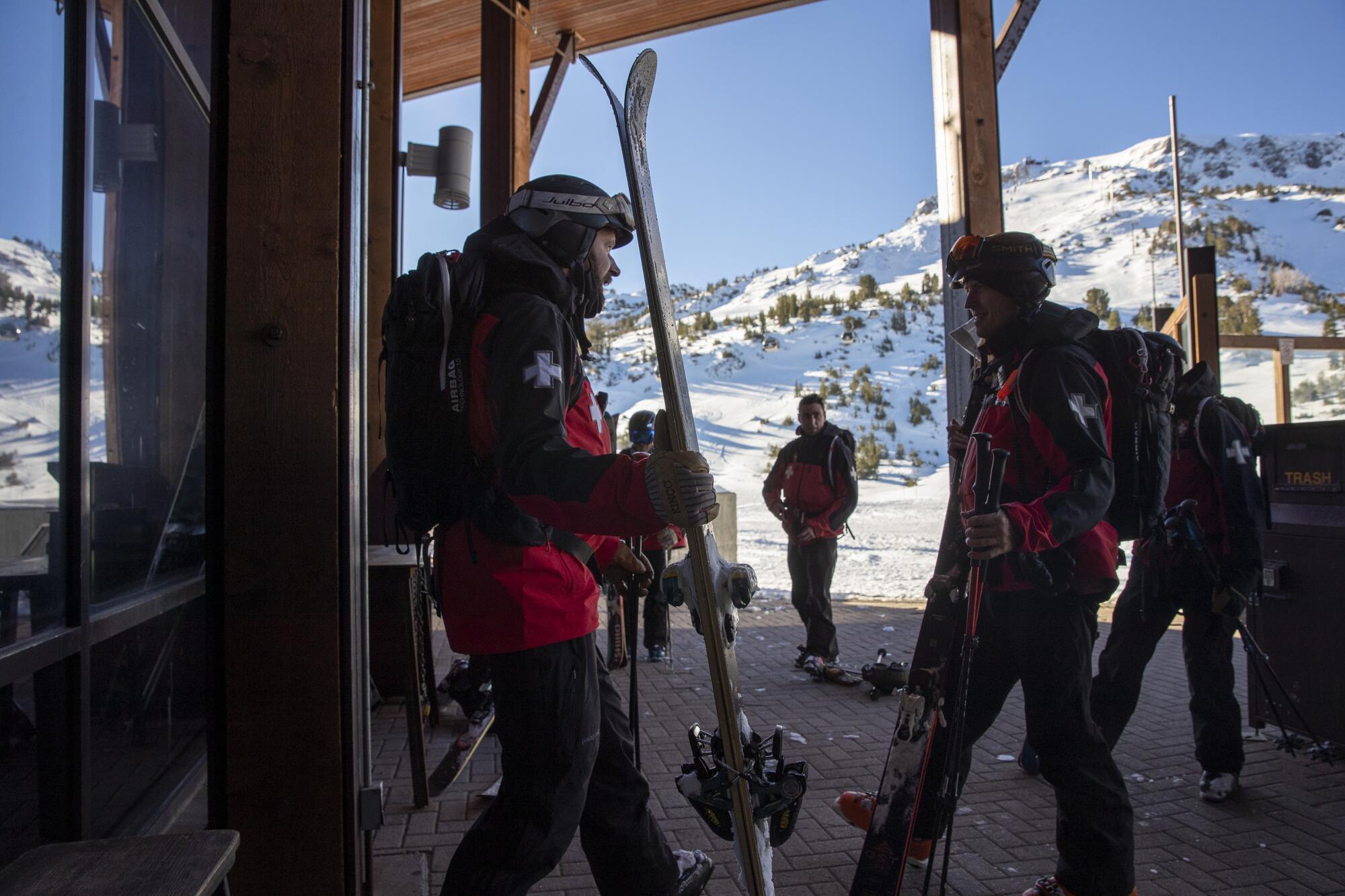 Mammoth Mountain ski patrol members head out from the summit to ready the slopes 