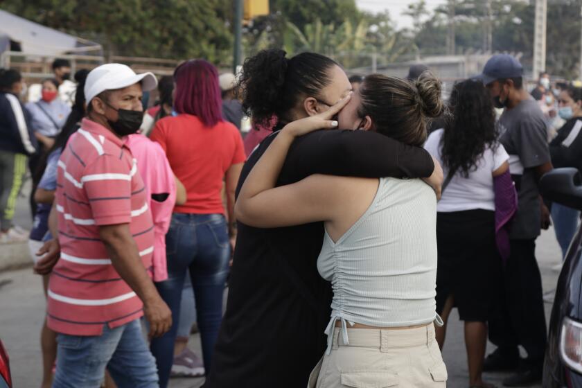 Women hug while waiting for some information about their relatives who are inmates at Litoral Penitentiary, after a prison riot, in Guayaquil, Ecuador, Wednesday, September 29, 2021. The authorities report at least 100 dead and 52 injured in the riot on Tuesday at the prison. (AP Photo/Angel DeJesus)
