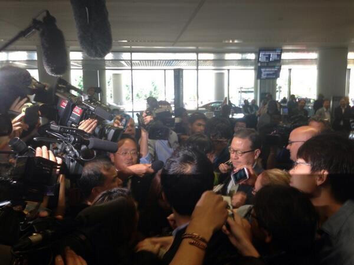 Asiana Airlines President Yoon Young-doo is swarmed by reporters upon his arrival at San Francisco International Airport.