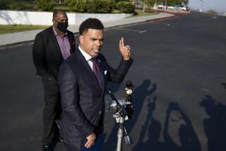 Shane Harris, President of the People's Association of Justice Advocates speaks as Bishop Cornelius Bowser, Director of Shaphat Outreach looks on at a news conference held at Grossmont High School September 8, 2021 in La Mesa. (Photo by Denis Poroy)