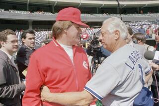 Cincinnati Reds manager Pete Rose and Los Angeles Dodger manager Tom Lasorda hug prior to the start of their National League opening game at Riverfront Stadium, Cincinnati, April 3, 1989. (AP Photo/Al Behrman)