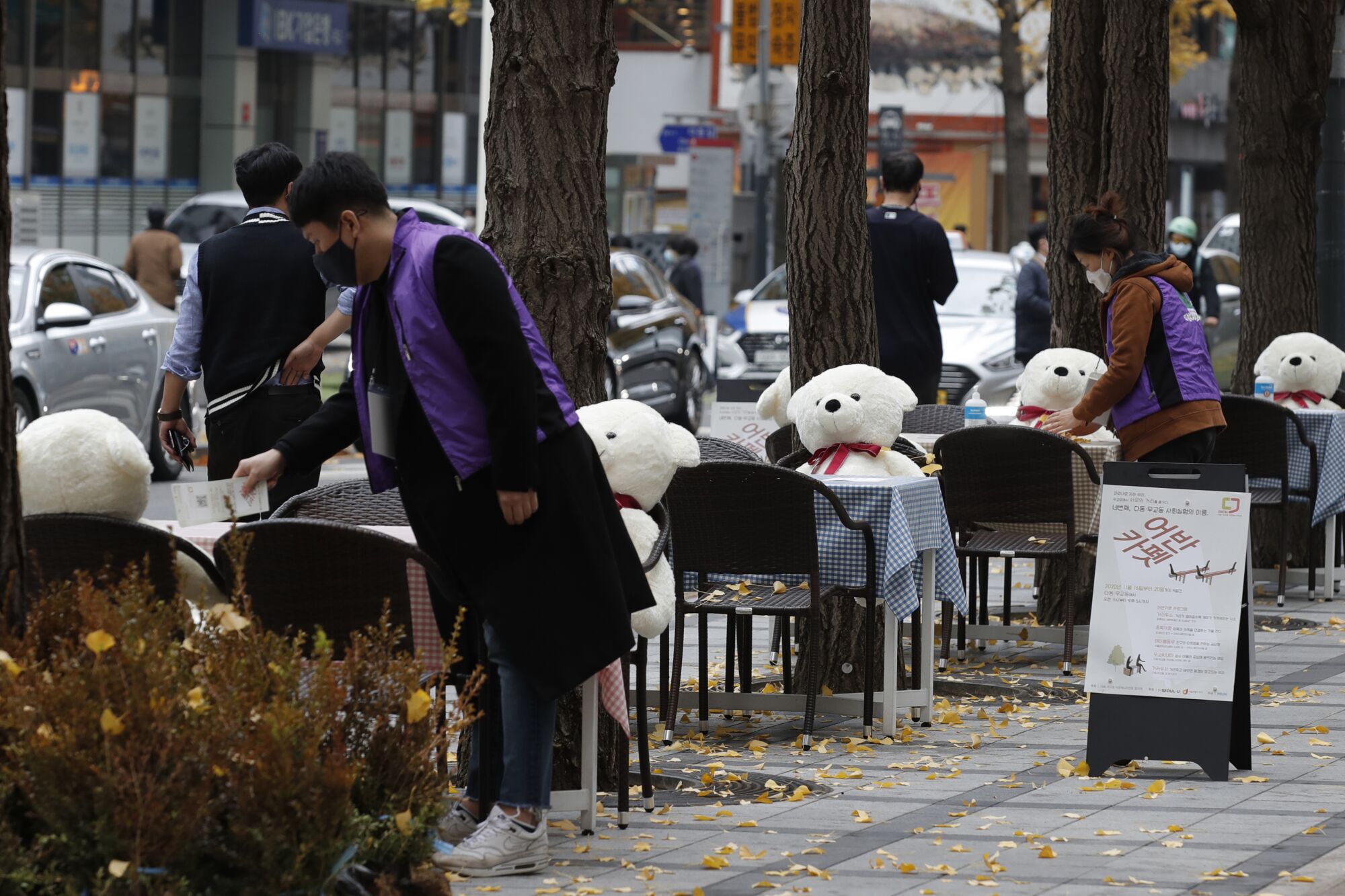 An outdoor dining set-up with hand sanitizers and stuffed bears to enforce social distancing in downtown Seoul.