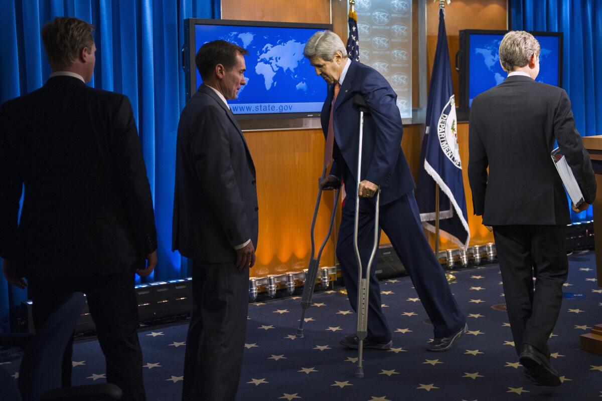 Secretary of State John F. Kerry leaves the lectern after presenting the State Department's annual human rights report in Washington. Kerry remains on crutches as he recovers from a bicycle accident.